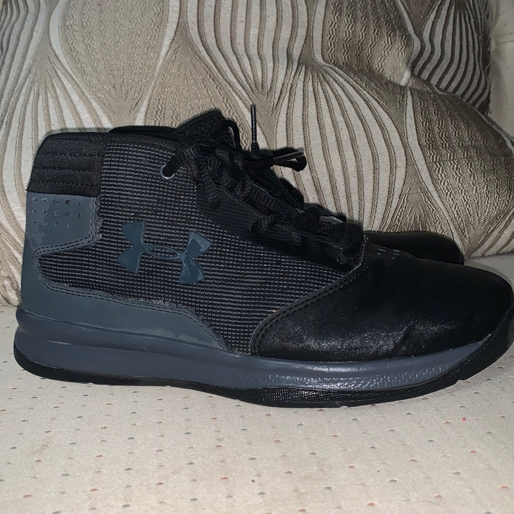Boys black Under Armor high tops.